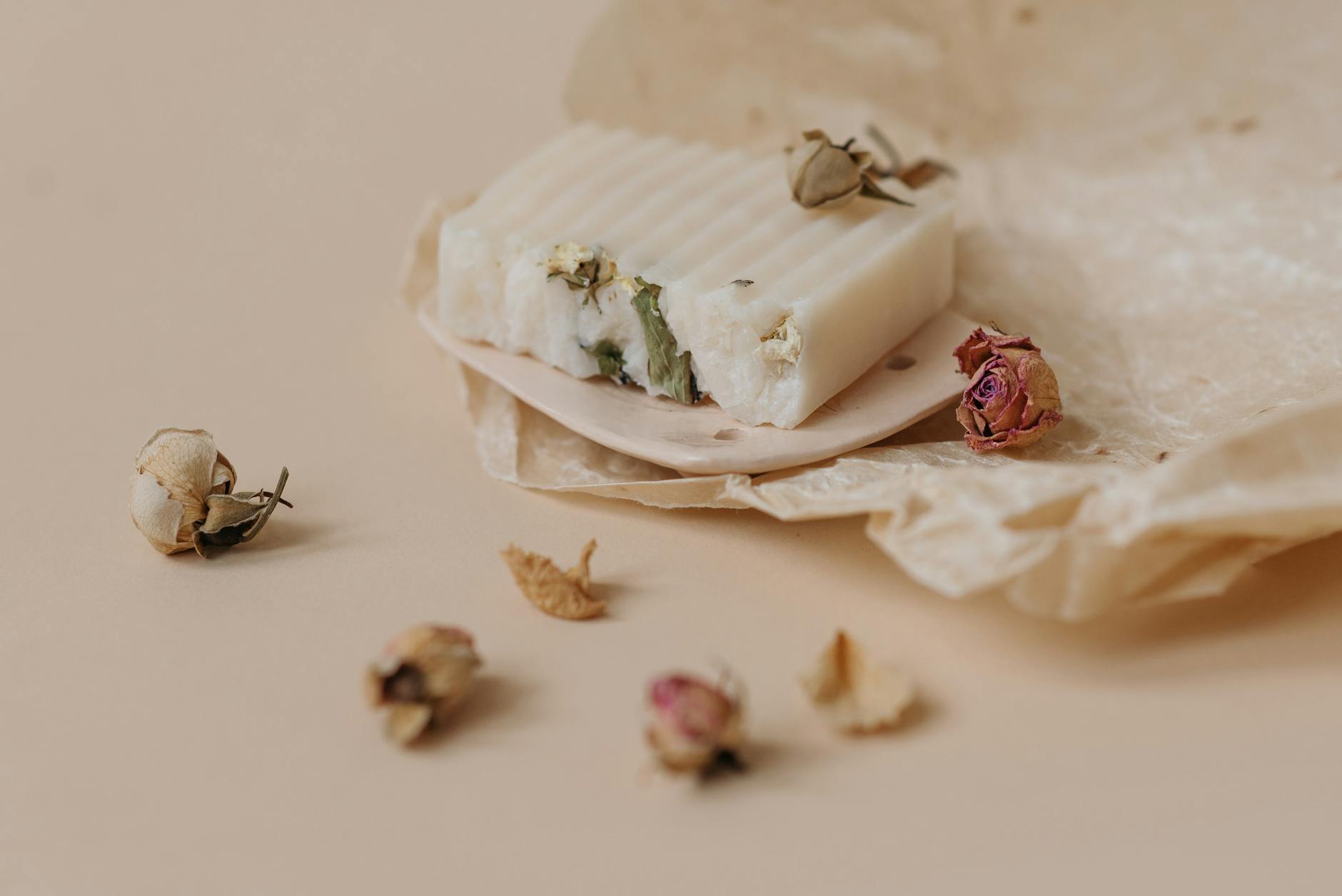 a bar of soap on a beige ceramic dish