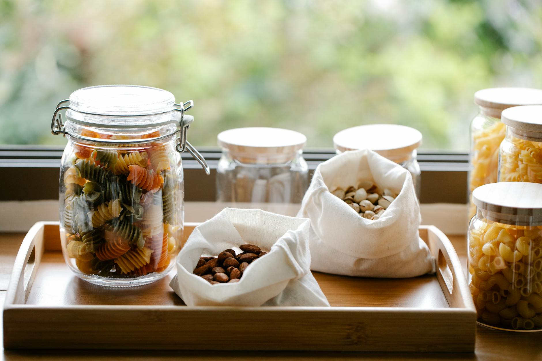 raw pasta near sacks with nuts