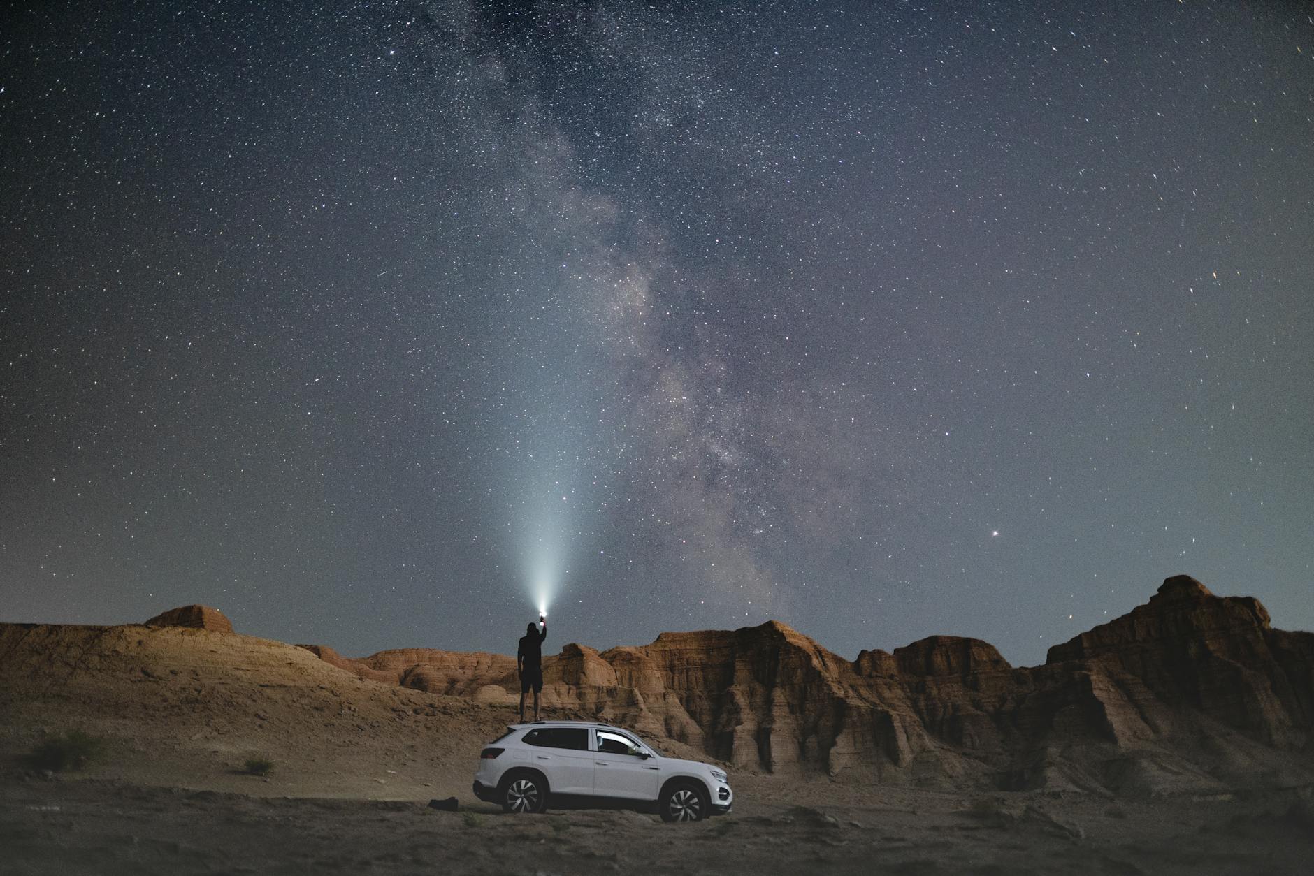 person standing near vehicle during nighttime