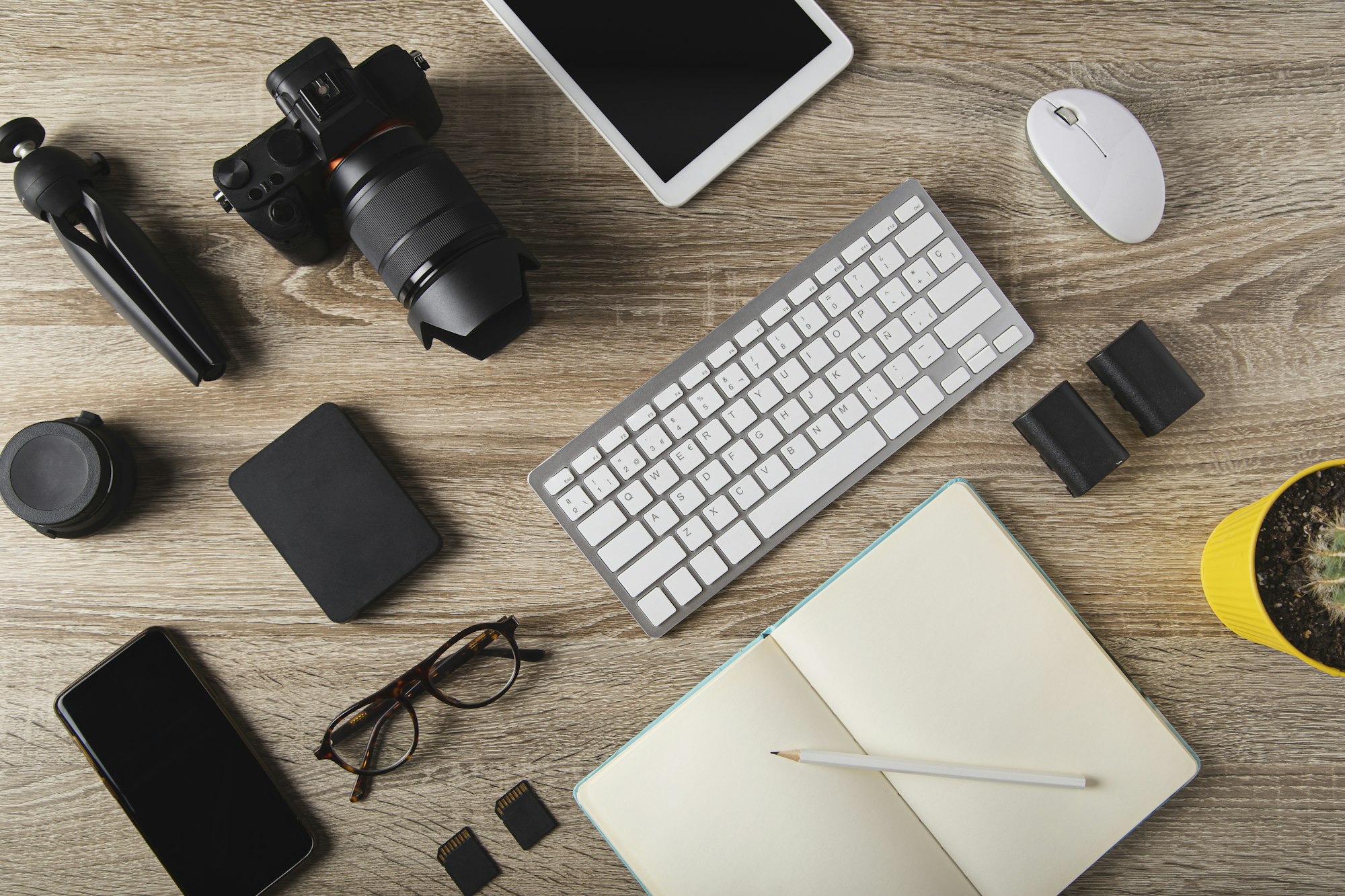 top view of photographer workstation, workspace concept with digital camera, laptop,